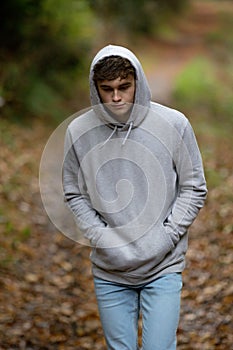 Teenage boy walking alone on an atumn day