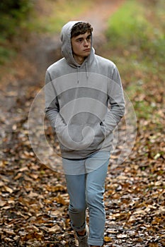 Teenage boy walking alone on an atumn day