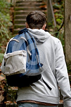 Teenage boy walking up concrete steps