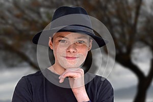 Teenage boy wearing black fedora hat