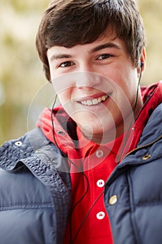 Teenage Boy Wearing Earphones Listening To Music