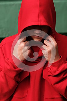 Teenage boy wearing fashionable red hoodie