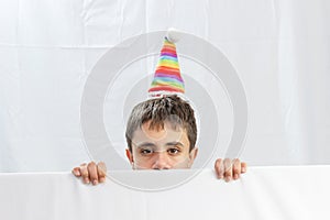 Teenage boy on a white background looking out at half of the face