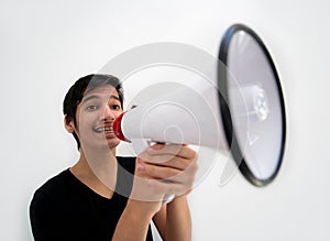 Teenage boy on white background with a megaphone