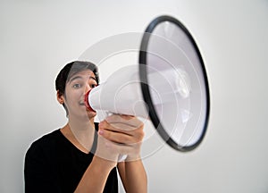 Teenage boy on white background with a megaphone
