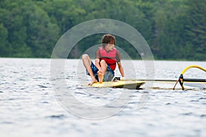 Teenage boy wind surfing