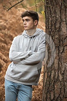 Teenage boy in the woods on an autumn day