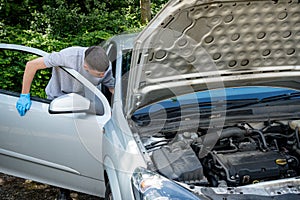 Teenage boy working on a car