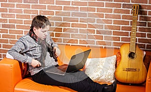 Teenage boy working on laptop. Concentration and composure.