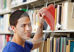 Teenage boy working in library