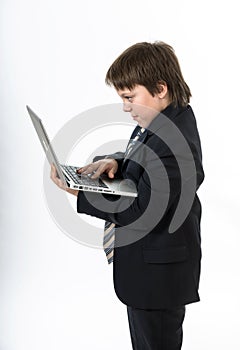 Teenage boy working in white laptop
