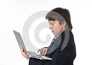 Teenage boy working in white laptop