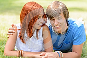 Teenage boyfriend and girlfriend lying on grass