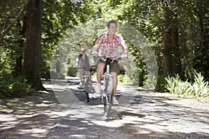 Teenage Boys Bicycling In Forest photo