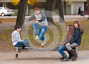 Teenage boys and girls having fun in the park