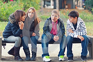 Teenage boys and girls having fun in spring park