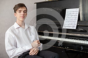 Teenage boys play piano in class or at home .