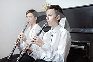 Teenage boys play piano in class or at home .