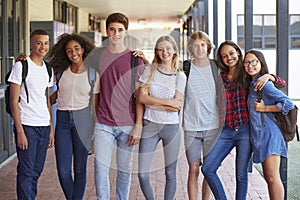 Teenage classmates standing in high school hallway photo