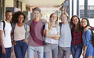 Teenage classmates standing in high school hallway photo