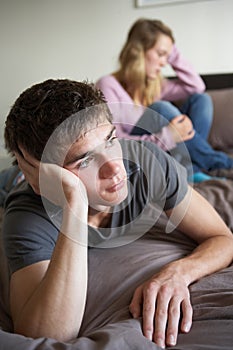 Teenage Couple In Bedroom After Argument