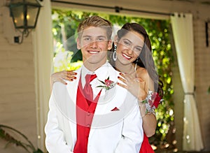 Teenage Couple Going to the Prom posing for a photo.