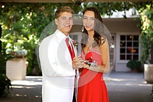 Teenage Couple Going to the Prom Posing and Smiling at Each Other