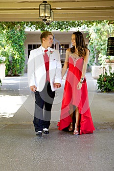 Teenage Couple Going to the Prom Walking and Smiling at Each Other