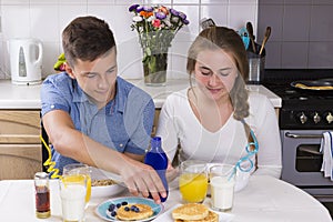 Teenage couple having breakfast together