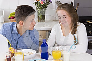 Teenage couple having breakfast together