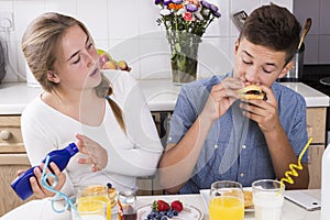 Teenage couple having breakfast together