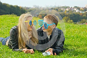 Teenage couple in huge funny glasses
