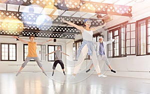 Teenage dancers jumping together during workout