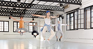 Teenage dancers jumping together during workout