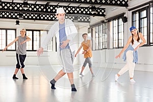 Teenage dancers practicing active dance at studio