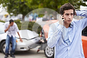 Teenage Driver Making Phone Call After Traffic Accident photo