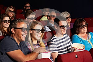 Teenage Family Watching 3D Film In Cinema