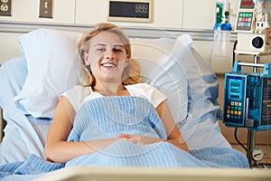 Teenage Female Patient Relaxing In Hospital Bed