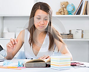 Teenage female is preparing herself for exams