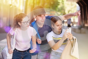 Teenage friends enjoying walk around city in summer