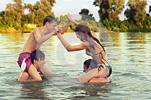 Teenage friends having fun in the river