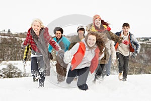 Teenage Friends Having Fun In Snowy Landscape