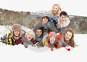 Teenage Friends Having Fun In Snowy Landscape