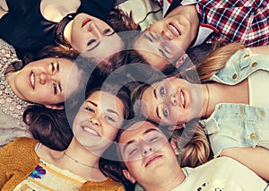 Teenage friends lying together in circle