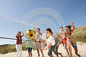 Teenage Friends Playing Volleyball On Beach