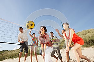 Teenage Friends Playing Volleyball On Beach