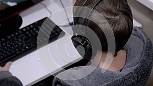 Teenage Gamer in Headphones, Sit in Armchair, Playing Video Games on Computer