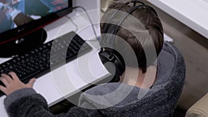 Teenage Gamer in Headphones, Sit in Armchair, Playing Video Games on Computer