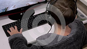 Teenage Gamer in Headphones, Sit in Armchair, Playing Video Games on Computer