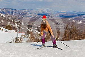 Teenage girl on alpine skiing in winter